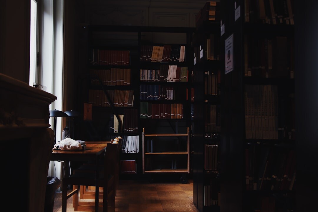 Cozy study room with tall wooden bookshelves full of old books