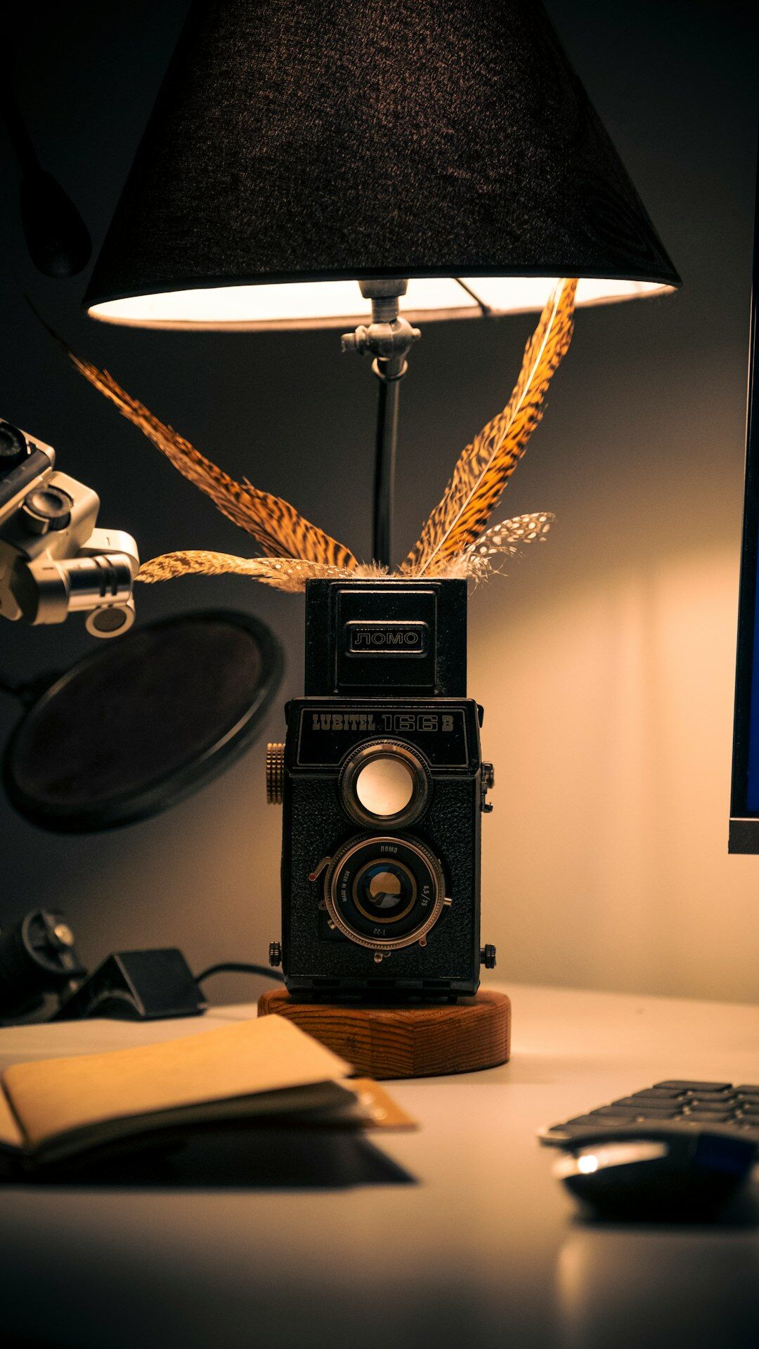 Old typewriter on a wooden desk lit by lamplight in a dim study